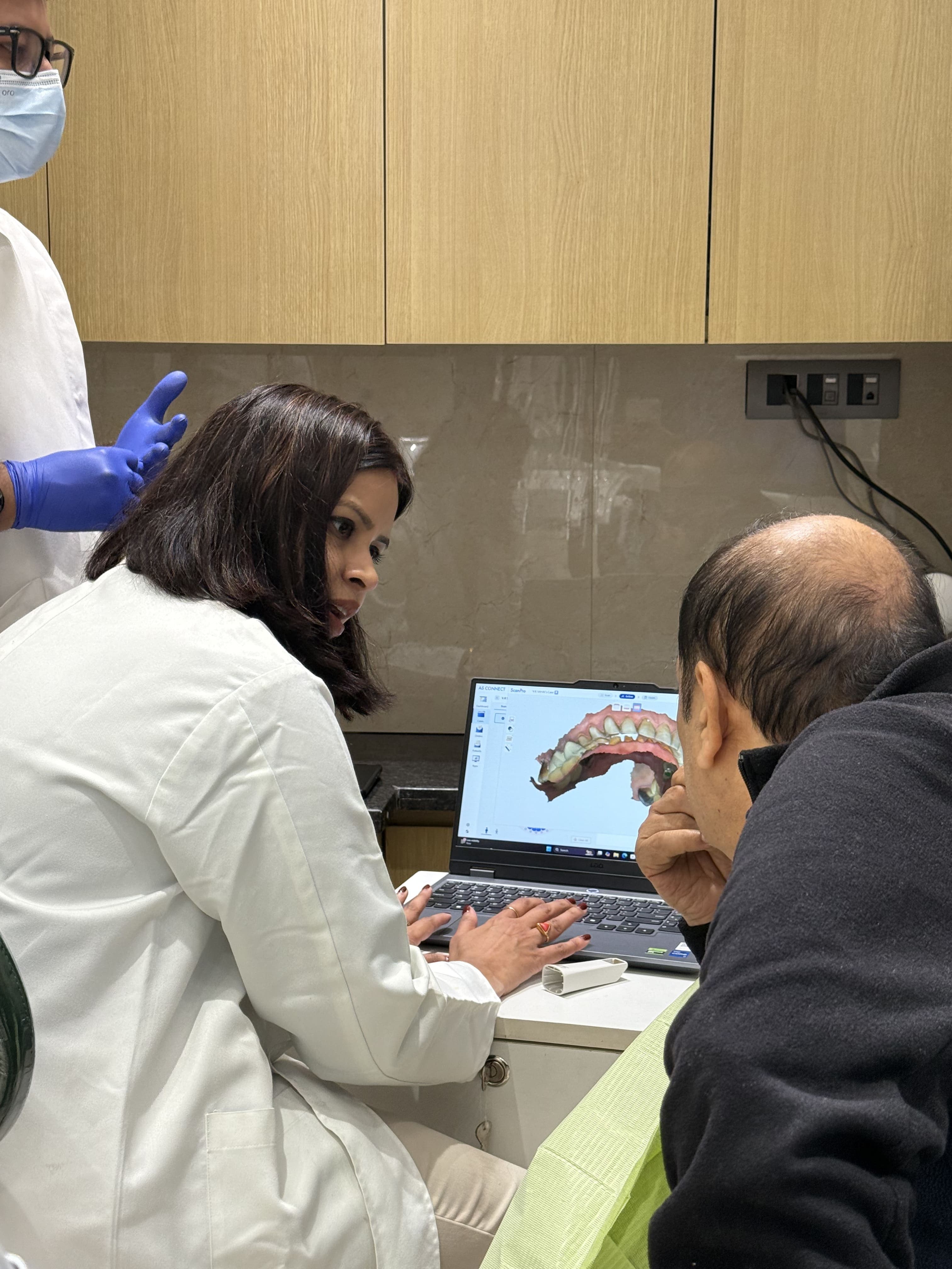 A dentist demonstrating a denture model at Renew Dental Clinic Noida, led by Dr. Suchi Singh, one of the best dentists in Noida Sector 47.