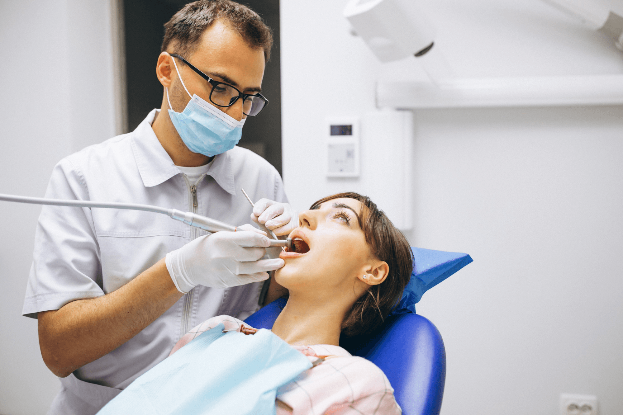 Patient sitting in a dental chair during a tooth extraction.