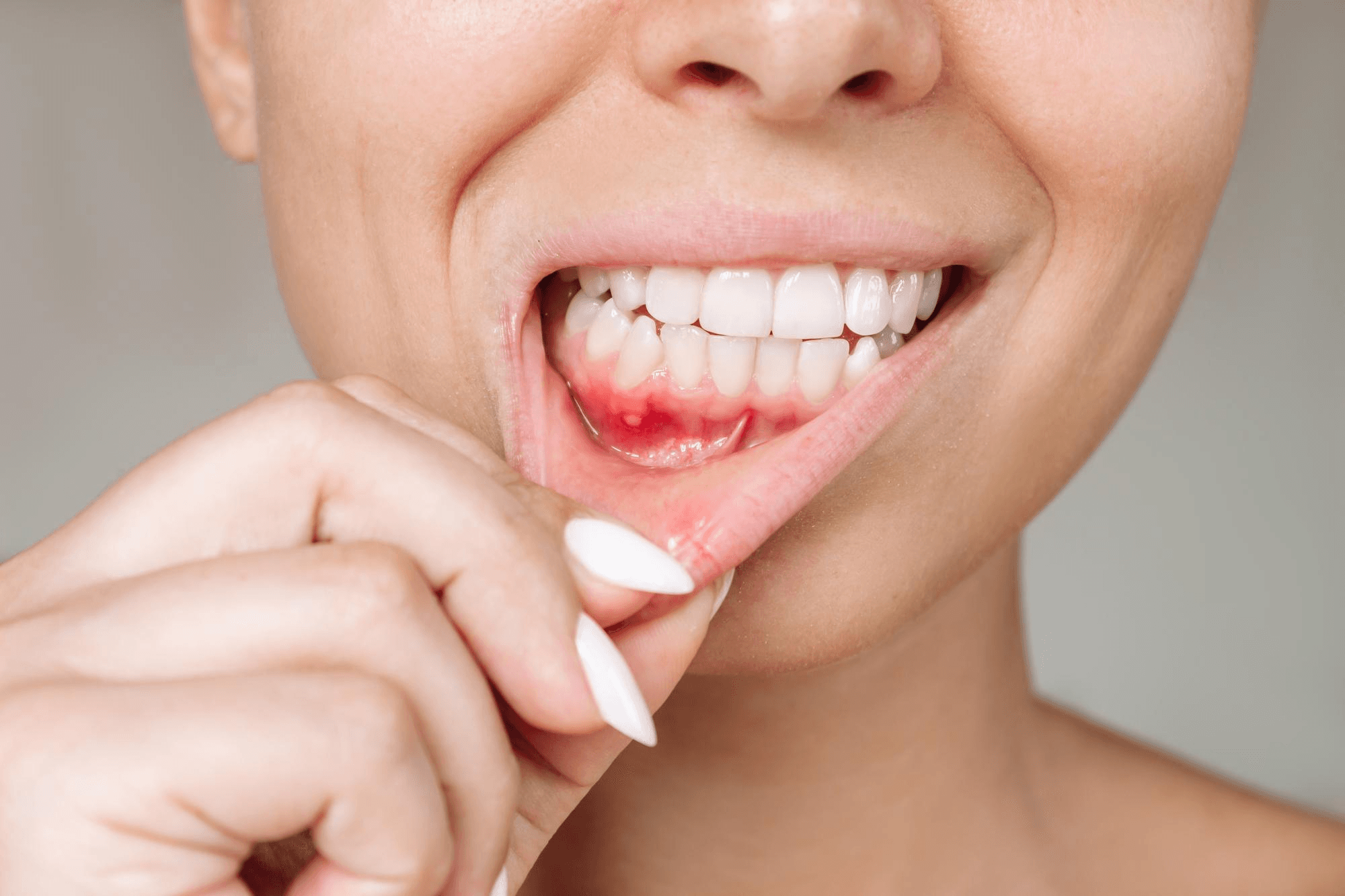 Woman brushing teeth.